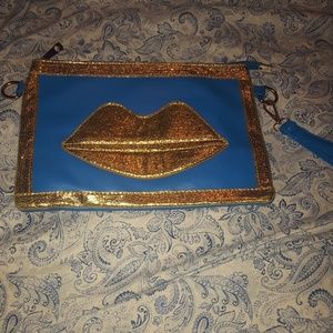 Gold lips and blue clutch